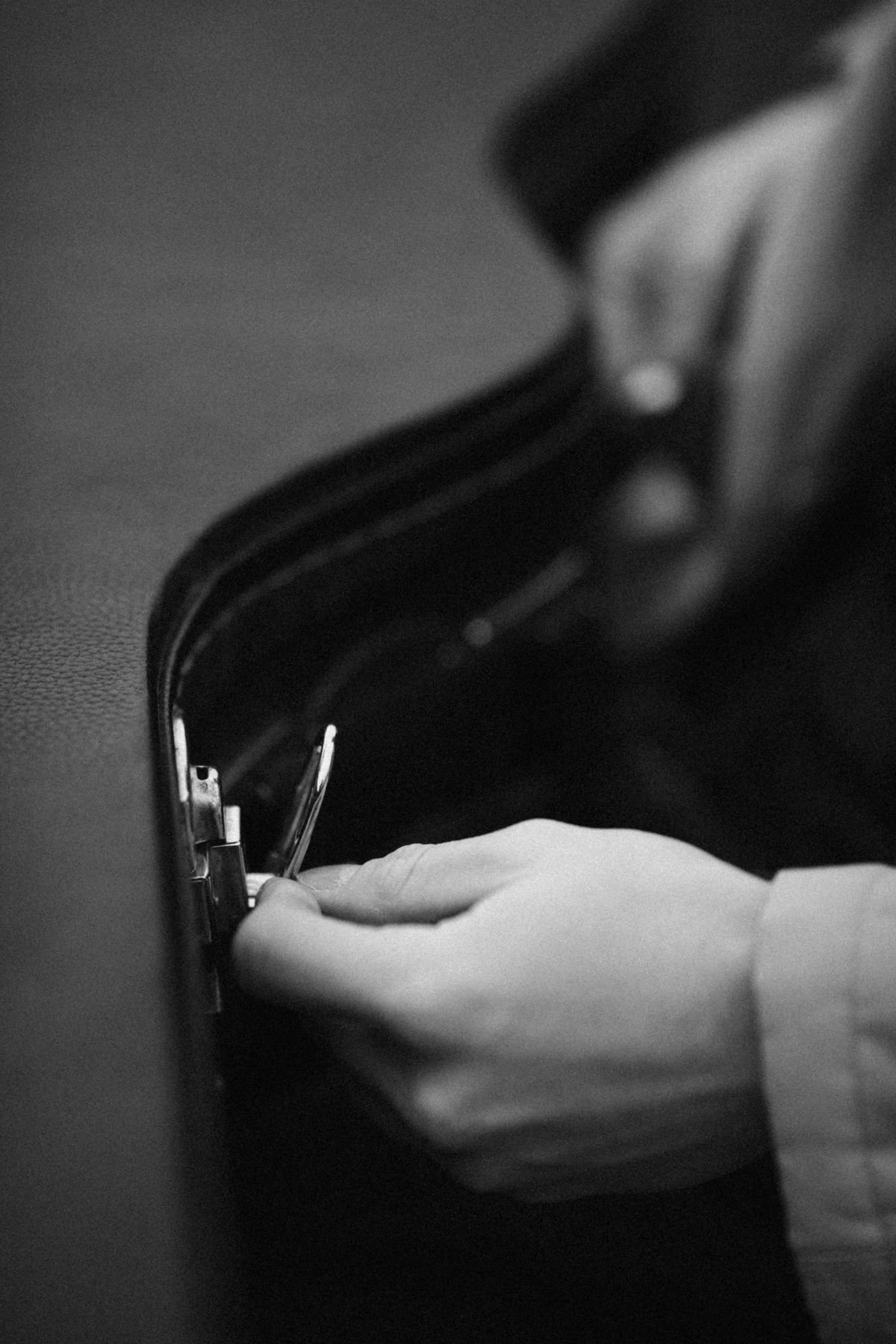 Hand opening a padded acoustic guitar gig bag