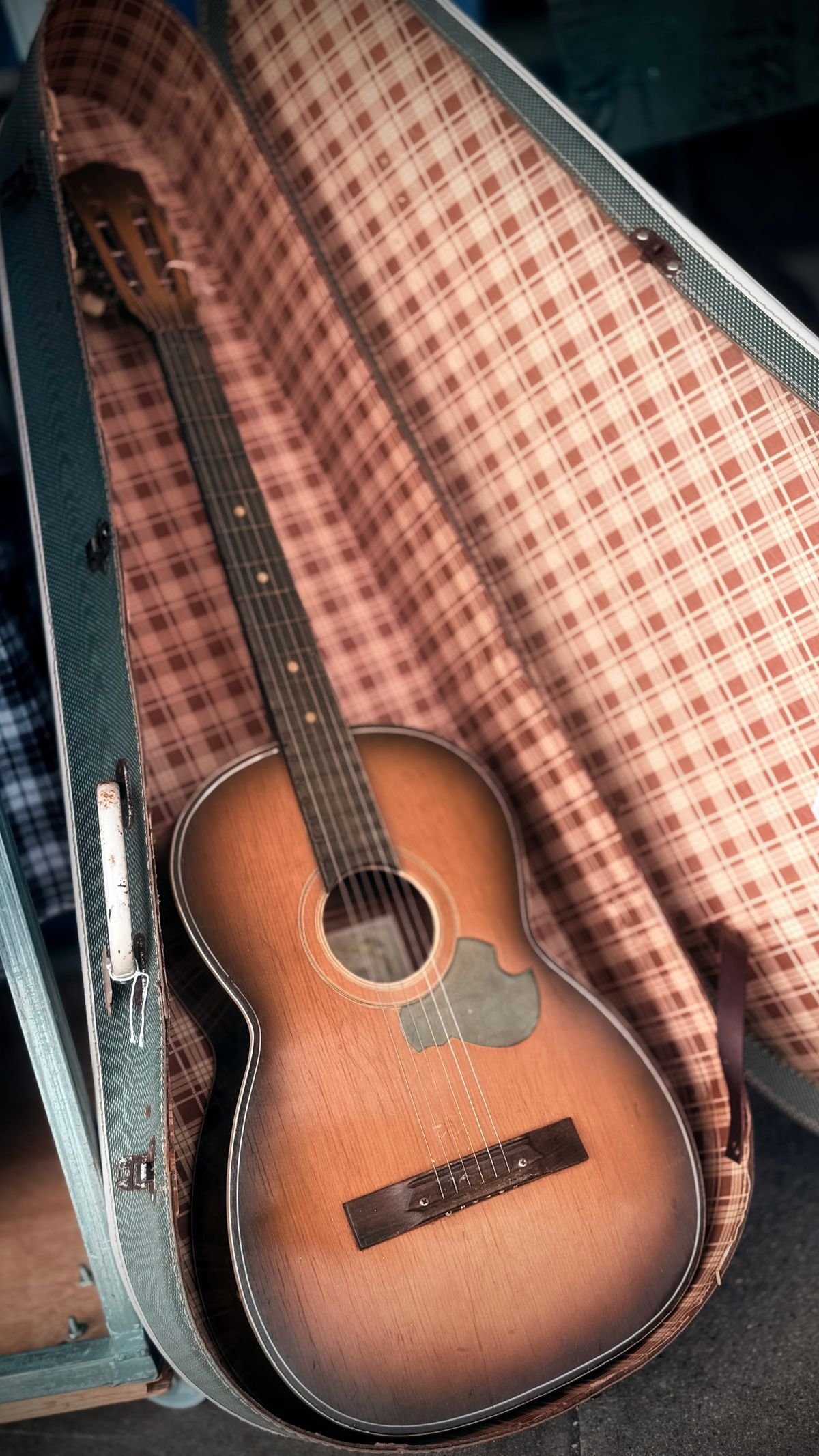 Hard case with a plush lined interior for a classical guitar