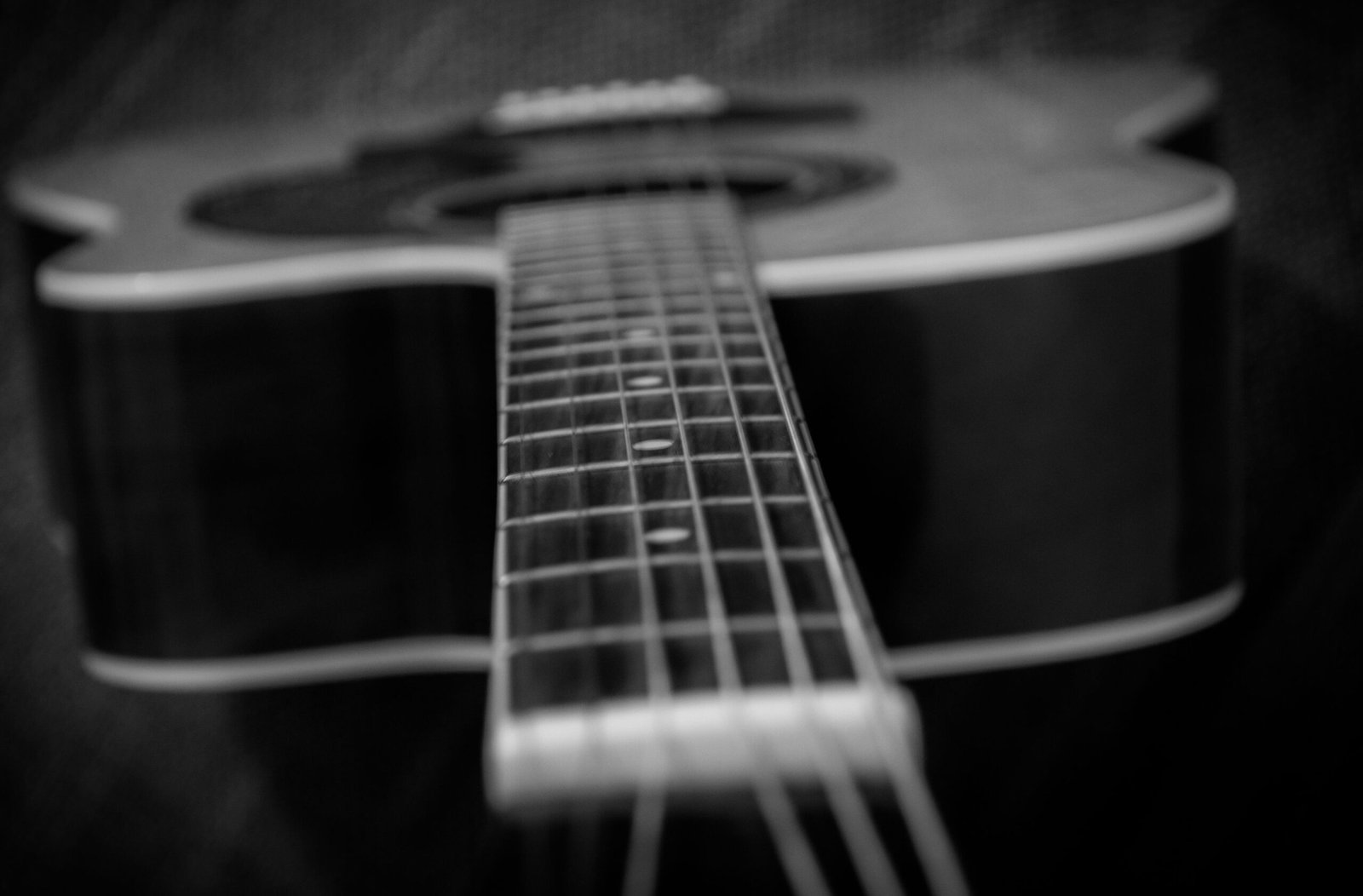 Close-up of a dark-bodied acoustic-electric guitar