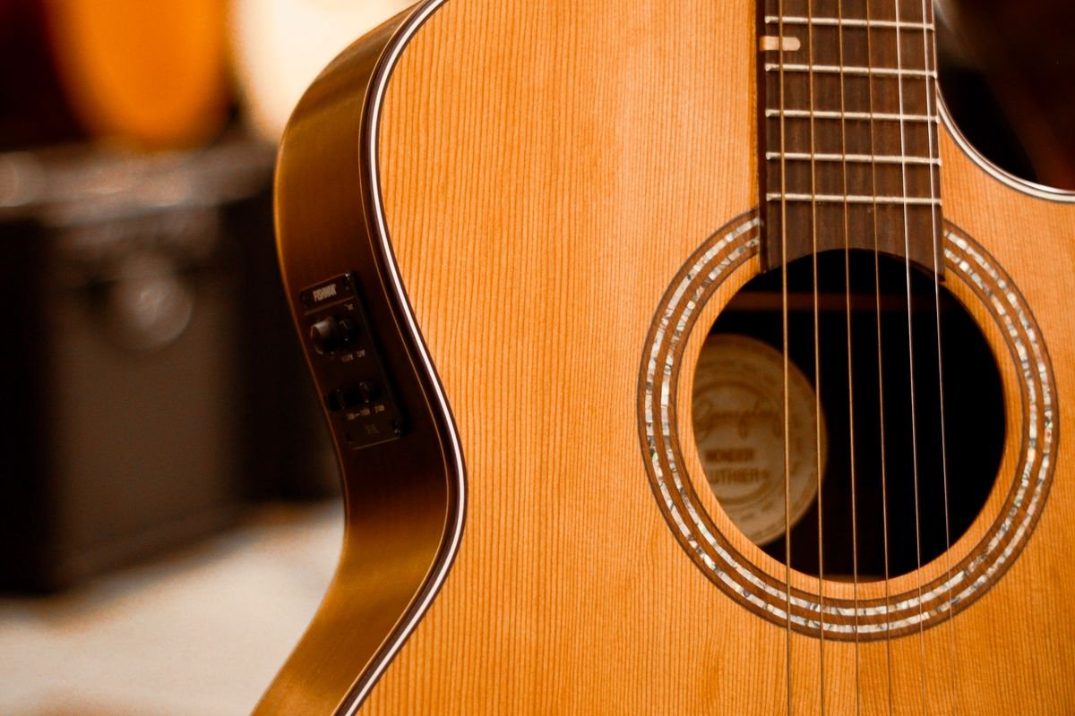 Close-up of an acoustic-electric guitar soundhole with an onboard preamp control panel