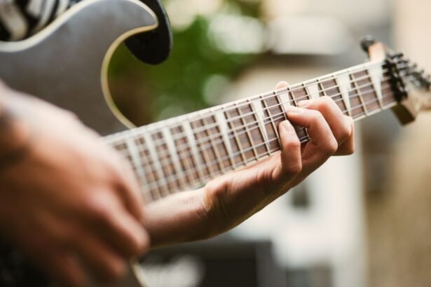 Close-up of a hand fretting notes on an electric guitar neck