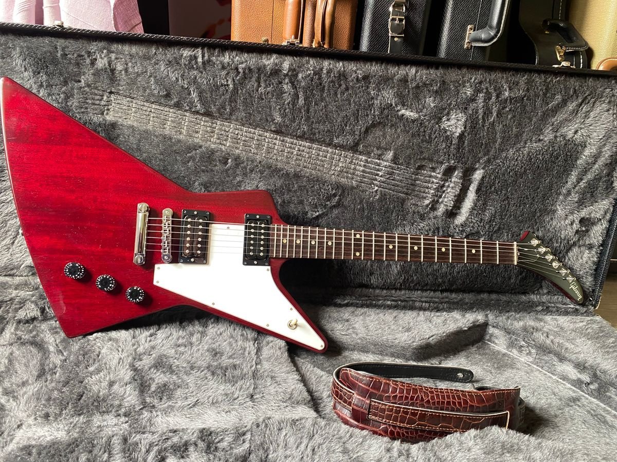 Open hard case with plush lining for a dreadnought-style guitar