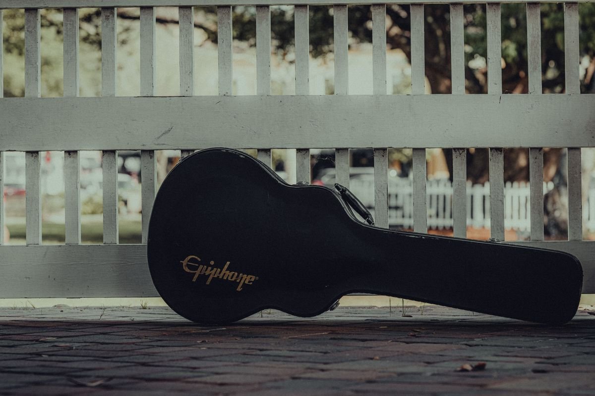 Acoustic guitar resting inside its case