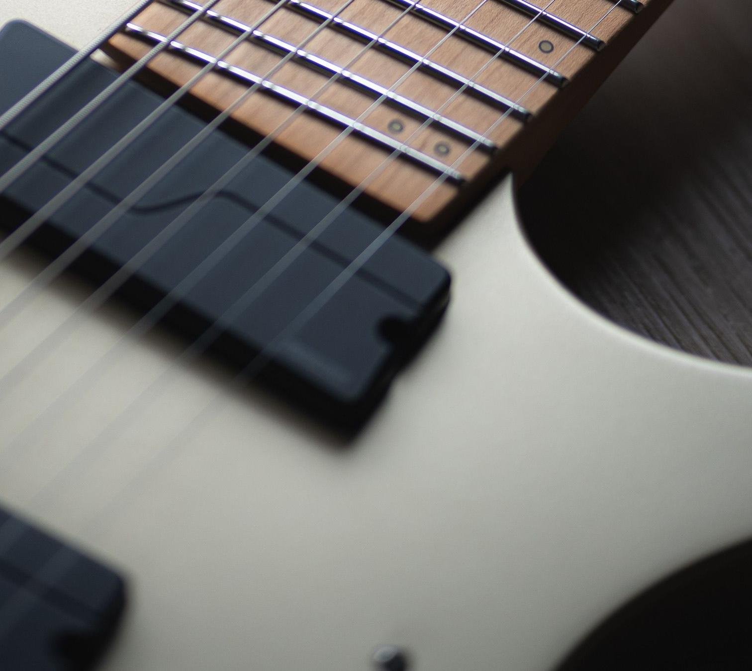 Close-up of a headless-style solid body electric guitar