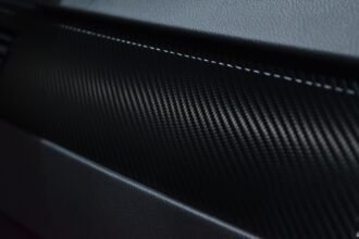 Close-up of woven carbon fibre texture, the composite material family used in the LAVA ME 4 body