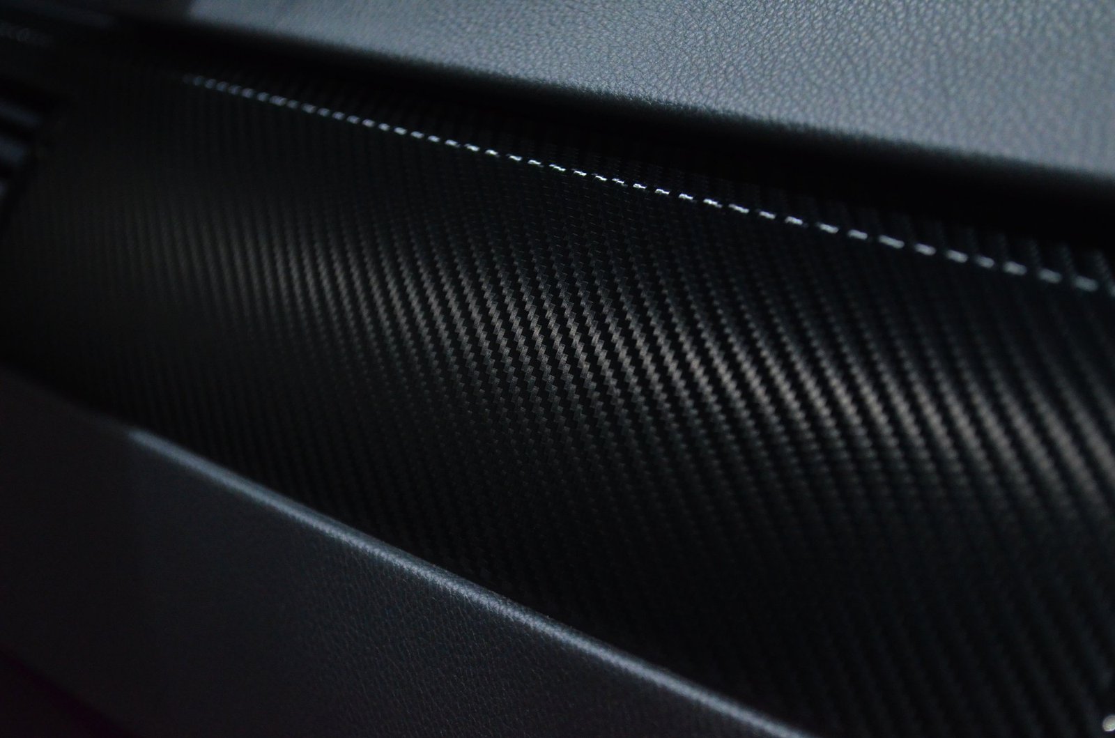 Close-up of woven carbon fibre texture, the composite material family used in the LAVA ME 4 body