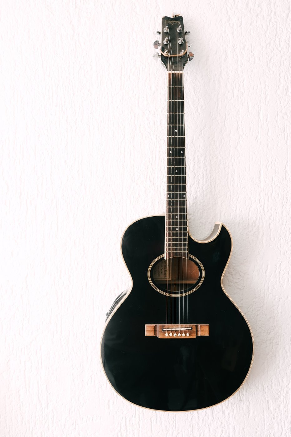 A dark acoustic-electric guitar body with cutaway, illustrating the style of body the LAVA ME 4 shares