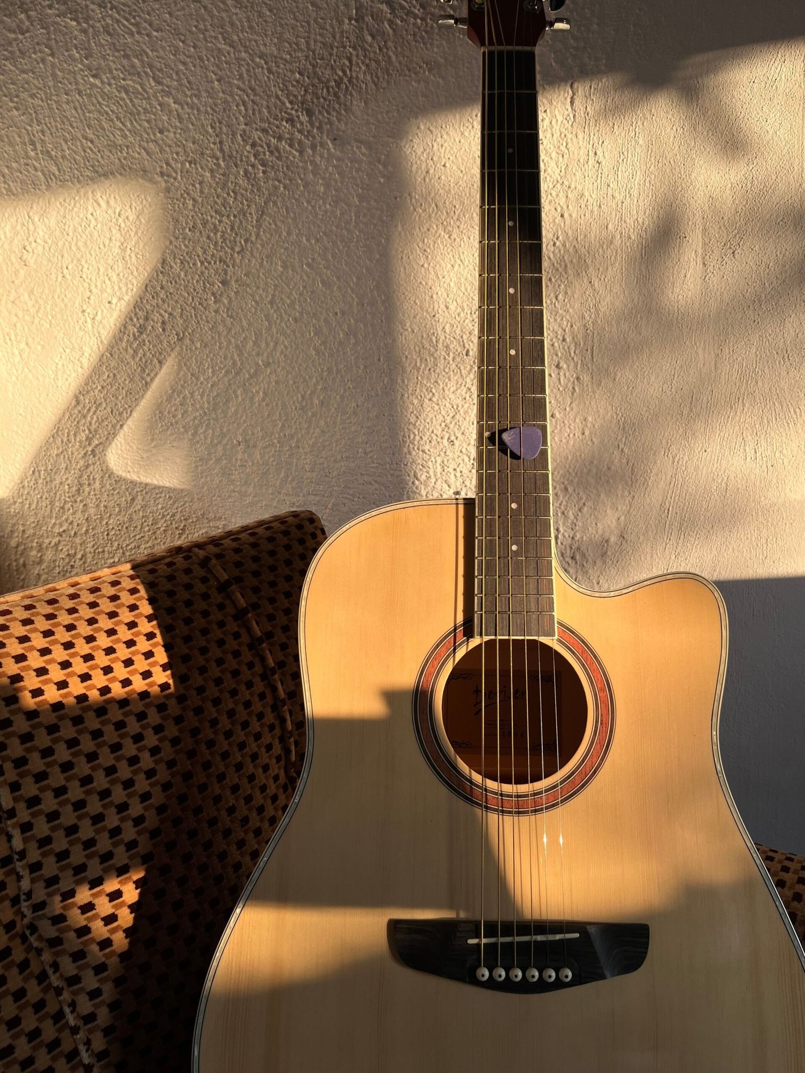 Natural-top cutaway acoustic-electric guitar