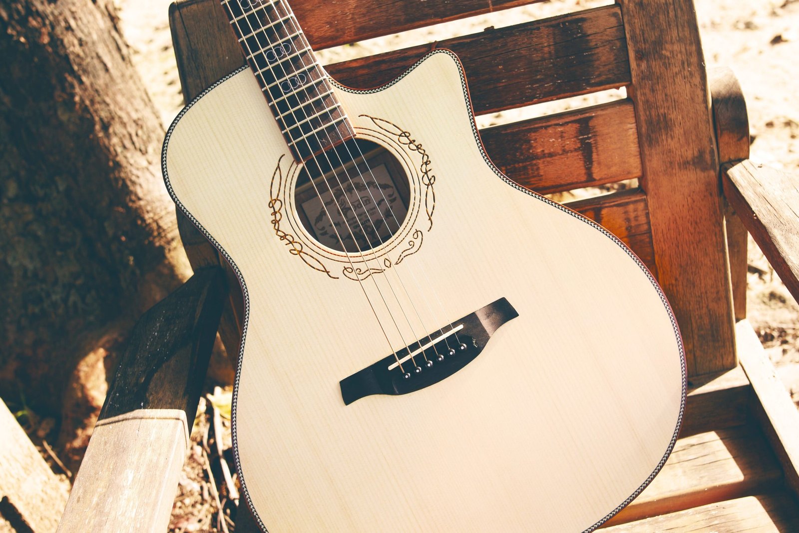 Small cutaway acoustic guitar in a pale natural finish