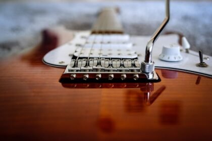 Close-up of a double-locking tremolo bridge and vibrato arm on an electric guitar