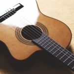 Close-up of a small acoustic guitar soundhole and rosette, the kind of detail that varies most between laminate and solid-top builds