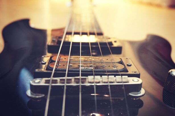 Close-up of a single humbucker pickup and fixed bridge on a solid-body electric guitar