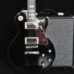 Close-up of a solid-body electric guitar with dual humbucker pickups, similar in layout to the Ibanez Gio miKro