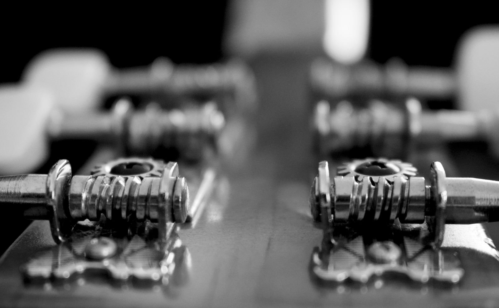 Close-up of guitar tuning pegs and machine heads in black and white