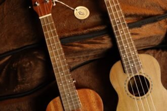 Two guitarlele necks with fretboard binding, similar to the Ortega Mini Travel Series