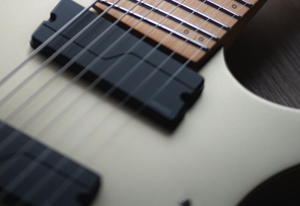 Close-up of a headless guitar bridge and fixed tuning system, the same in-body tuning concept the Traveler Pro-Series Standard uses
