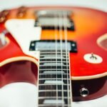 Close-up of an electric guitar body and humbucker pickup
