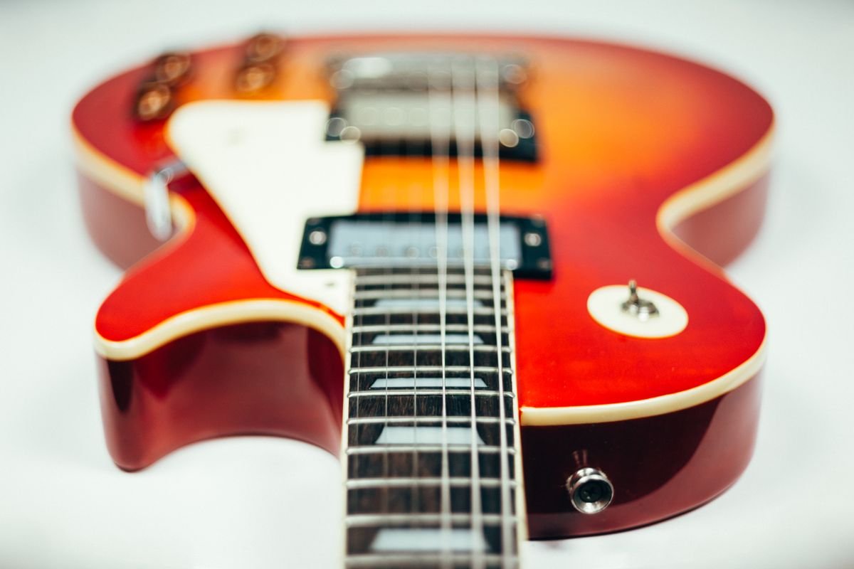 Close-up of an electric guitar body and humbucker pickup