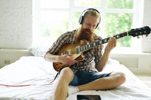 Practising an electric travel-style setup with headphones in a small bedroom