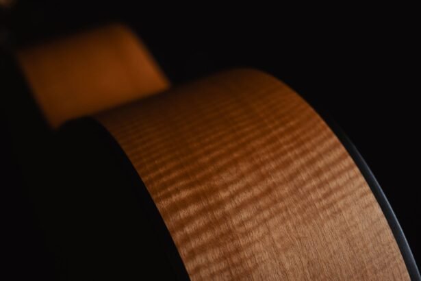 Close-up of an acoustic guitar side showing natural wood grain
