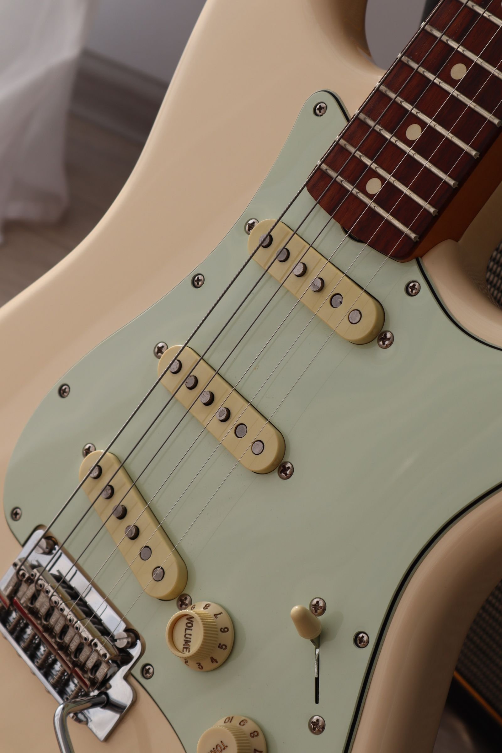 Close-up of an electric guitar's strings and humbucker pickup