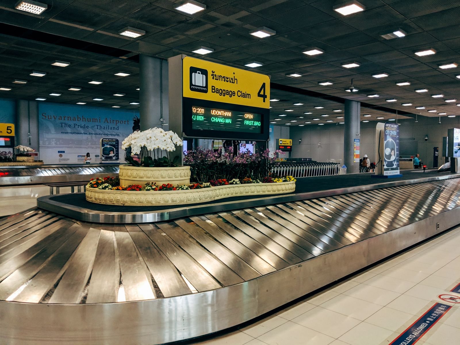 Empty baggage claim carousel in an airport arrivals hall