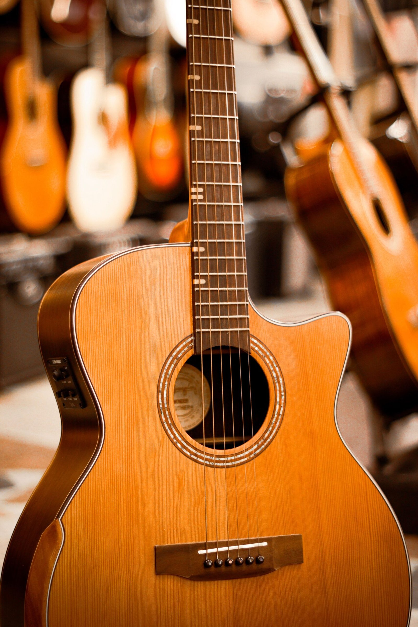 Acoustic guitars hanging on display in a guitar shop