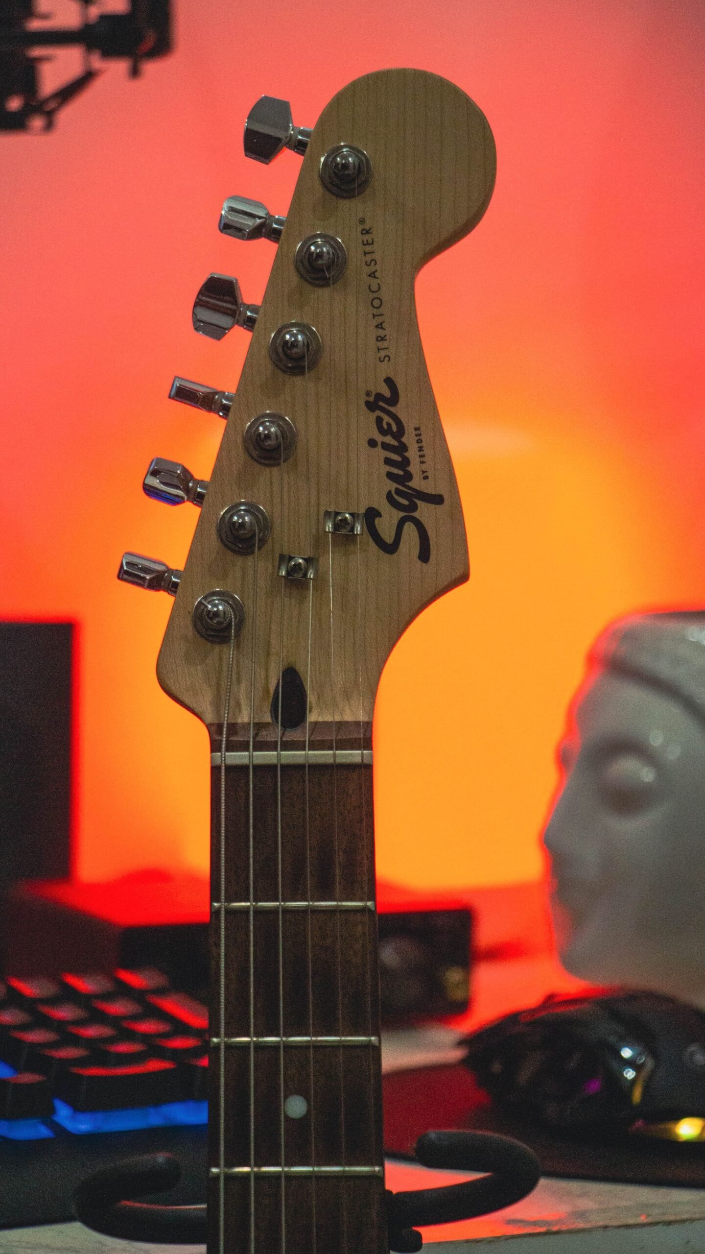 Close-up of a Stratocaster-style headstock and tuning pegs